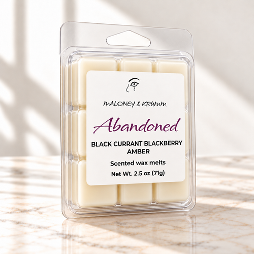 Abandoned scented wax melts with front label on white marble