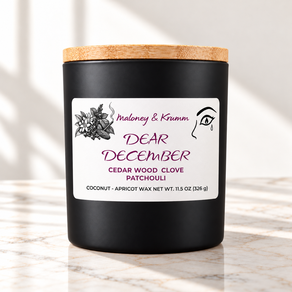 Dear December Signature candle on bright ivory marble tabletop