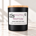 First Day candle in matte black jar on ivory marble with white background