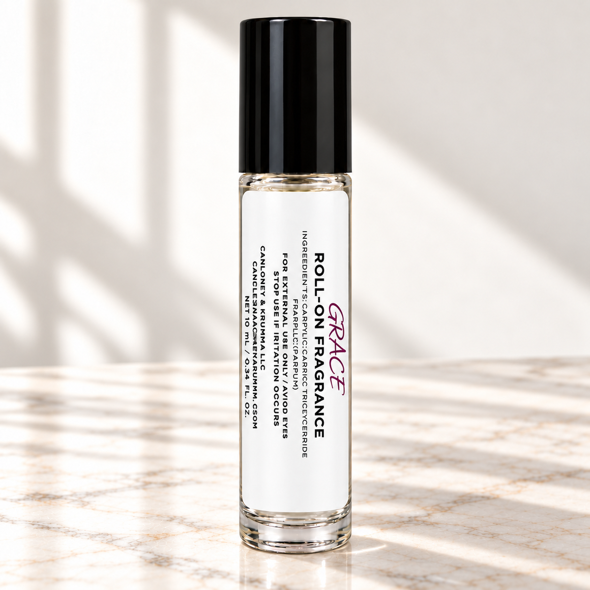 Grace 10 mL roll-on fragrance with full warning label on ivory marble and white background