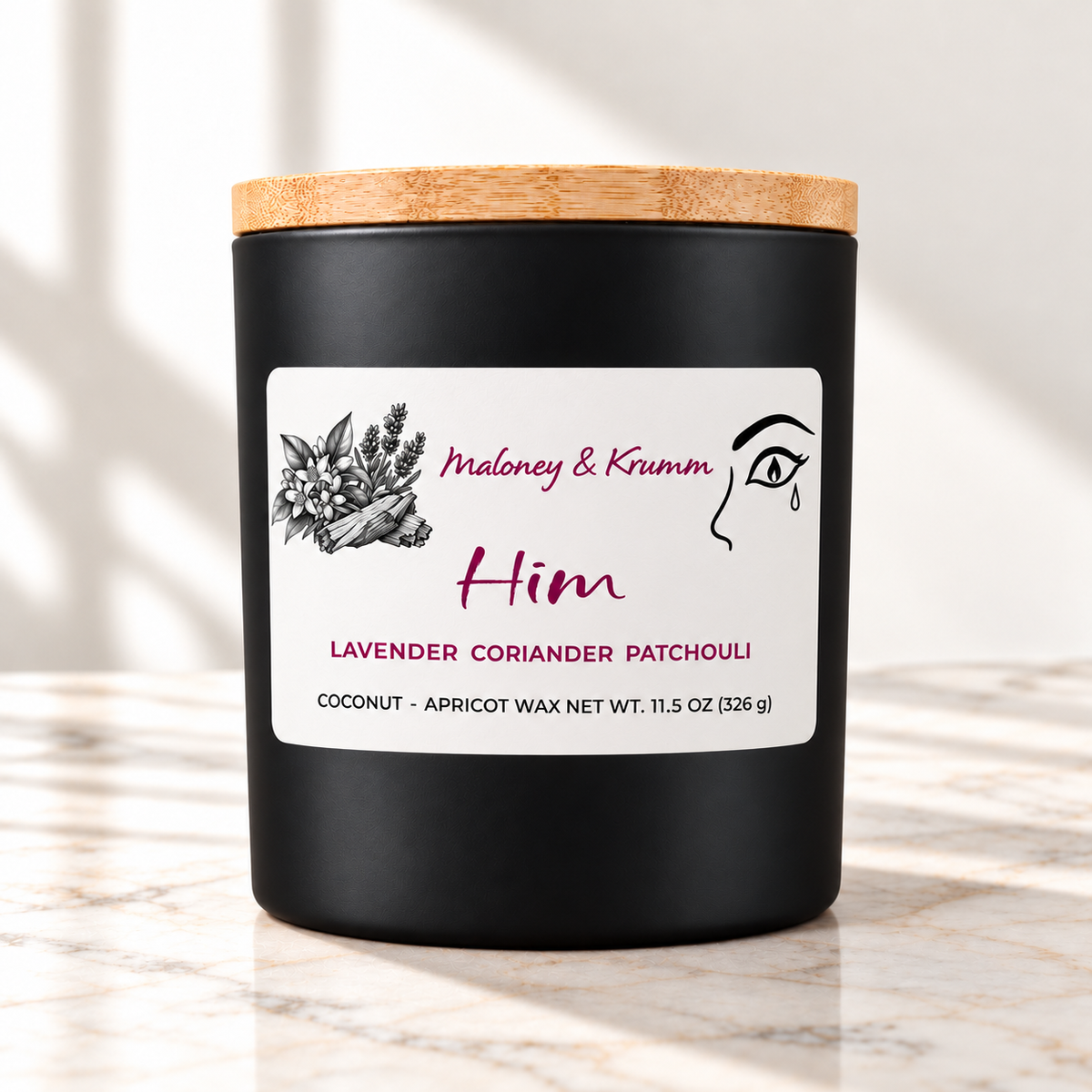 HIM candle in matte black jar on ivory marble with white background