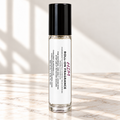 HIM 10 mL roll-on fragrance with full warning label on ivory marble and white background