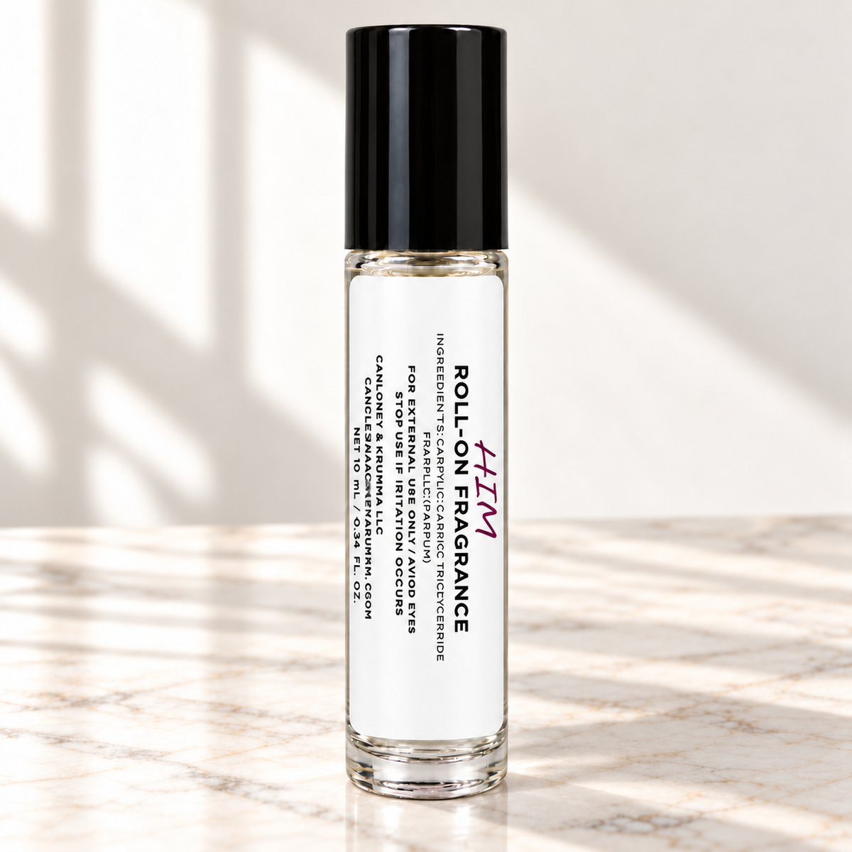 HIM 10 mL roll-on fragrance with full warning label on ivory marble and white background