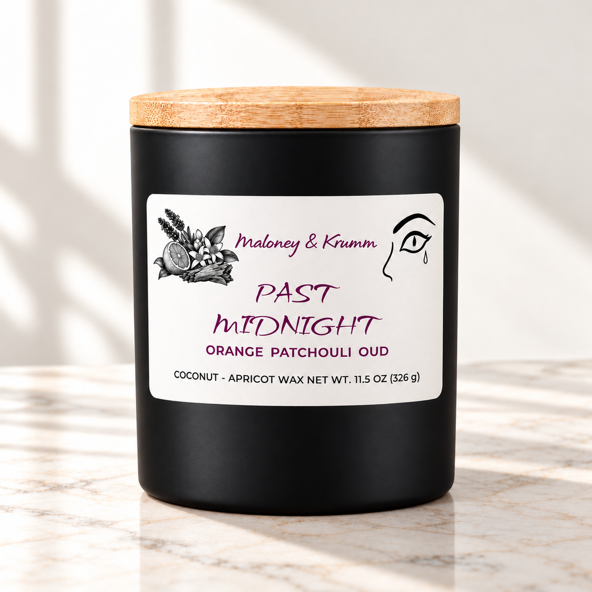 Past Midnight Signature candle on bright ivory marble tabletop