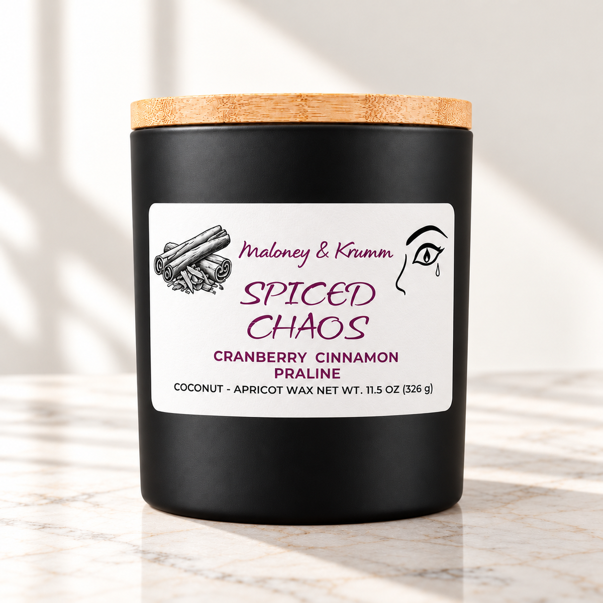 Spiced Chaos Signature candle on bright ivory marble tabletop