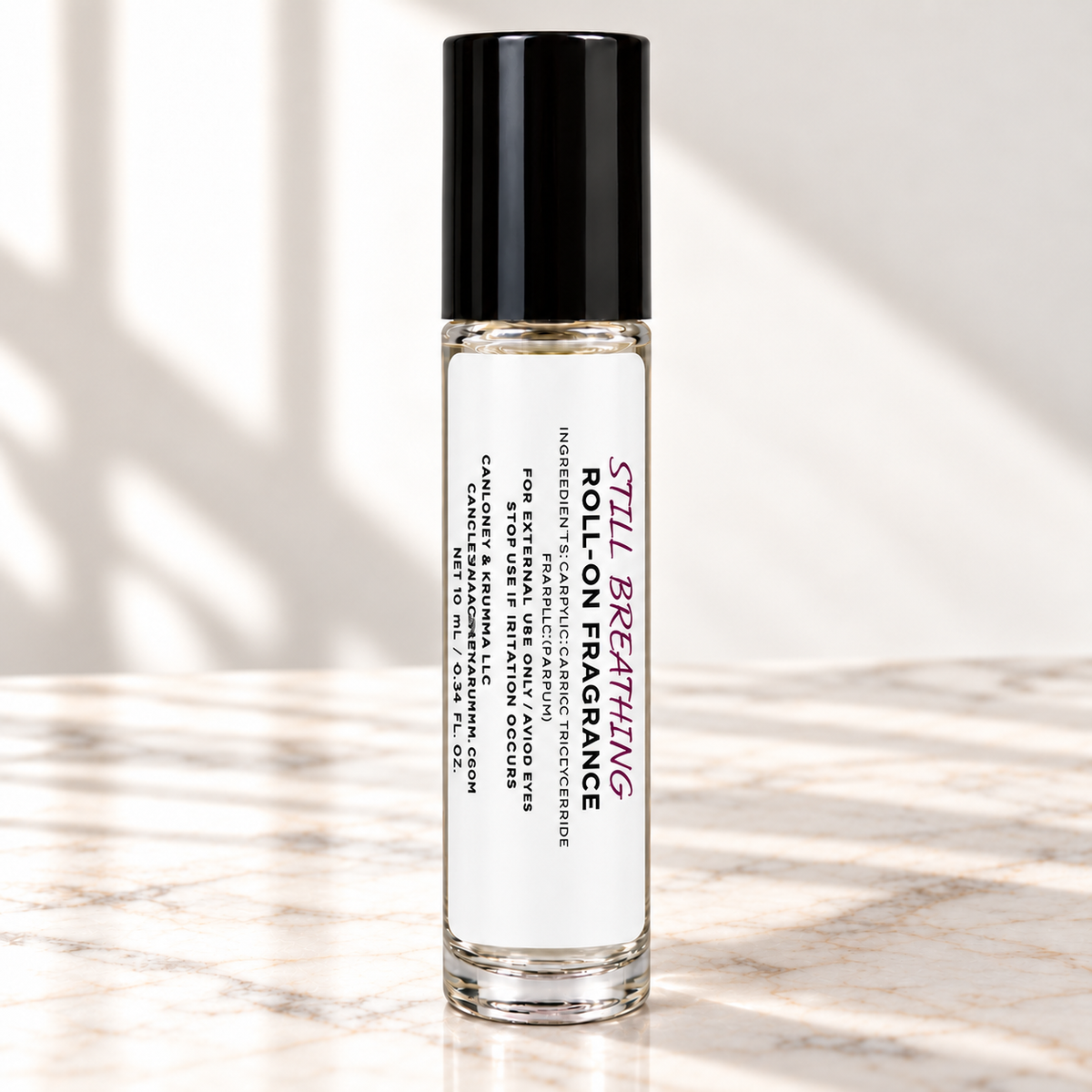 Still Breathing 10 mL roll-on fragrance with full warning label on ivory marble and white background