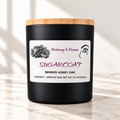 Sugar Coat candle in matte black jar on ivory marble with white background
