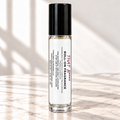 That Bitch 10 mL roll-on fragrance on ivory marble